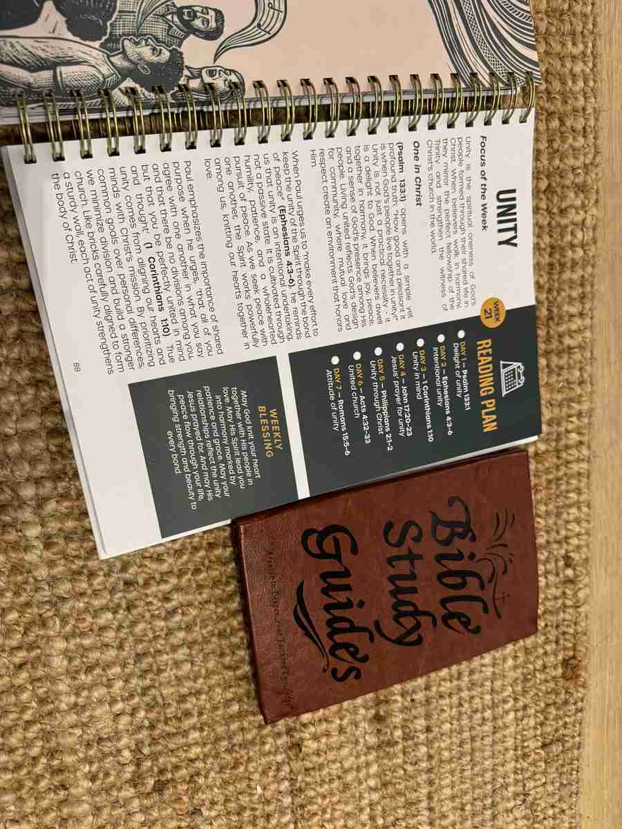 The Simple Bible Study by Everisma open to a weekly reading plan with daily scripture references, weekly blessing prayer, and gold spiral binding visible, next to the smaller Elvasma Bible Study Guide for size comparison